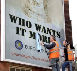 Workers in Maldova put up a billboard announcing the EURO Cup conference finals. The league is gaining a following throughout the continent.