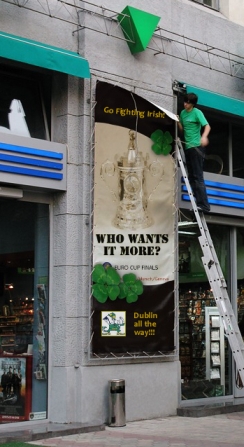 A worker in downtown Dublin posts a sign to show support for the Fighting Irish as they battle in the Northern Conference finals.
